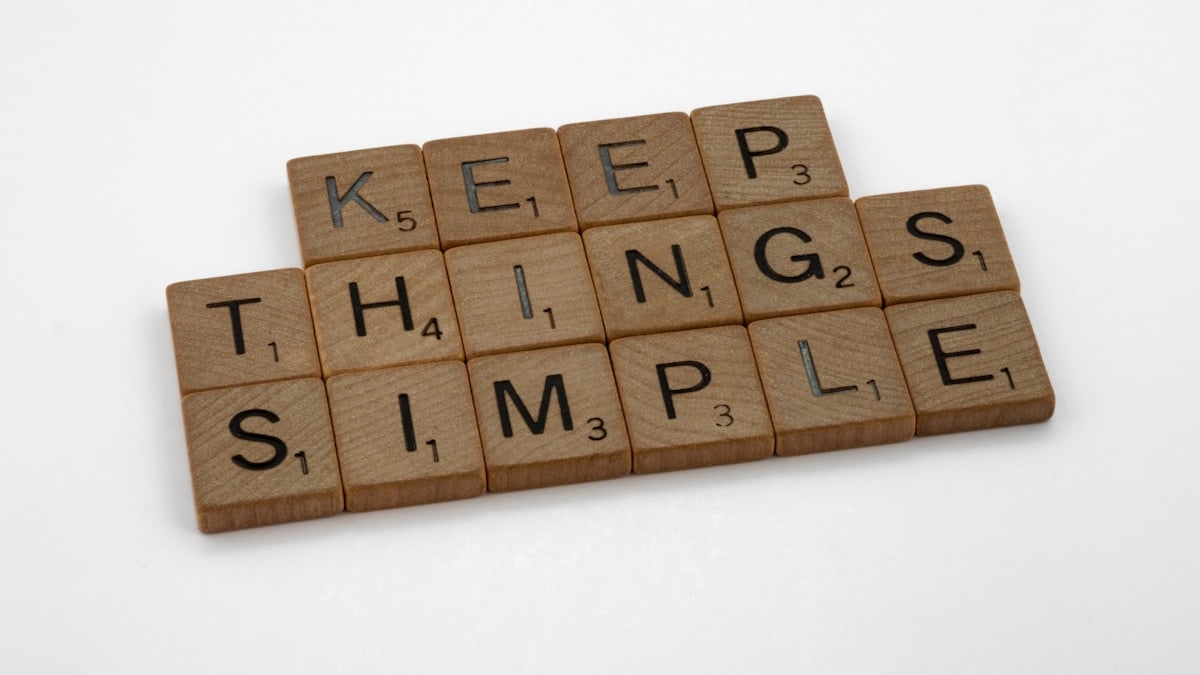 scrabble, scrabble pieces, lettering, letters, wood, scrabble tiles, white background, words, quote, letters, type, typography, design, layout, focus, bokeh, blur, photography, images, image, keep things simple, simplify, complexity, clutter, muddle, clear thinking, problem solving, secret of success, kiss, keep it simple stupid, occam razor, occam, 